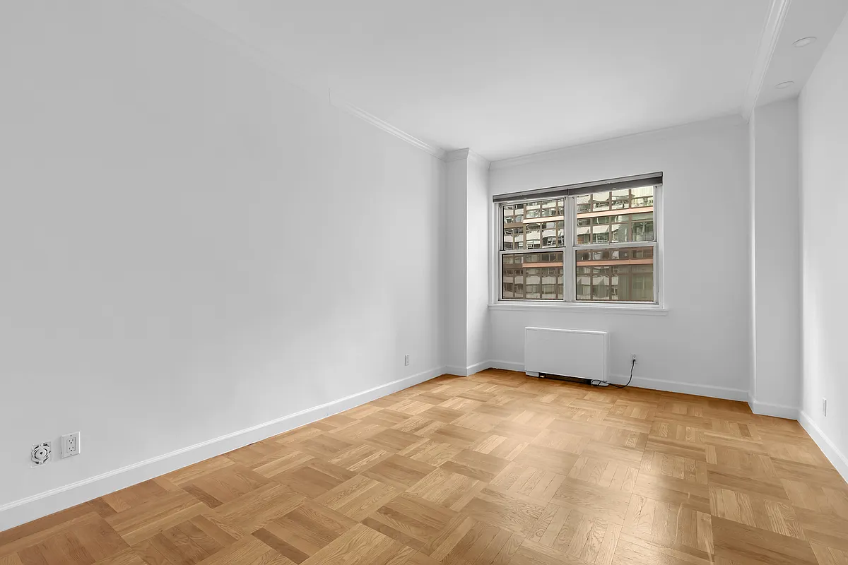 200 East 58th Street, Unit 15B Manhattan, NY 10022 - Photo 8 of 10 an empty room with a window