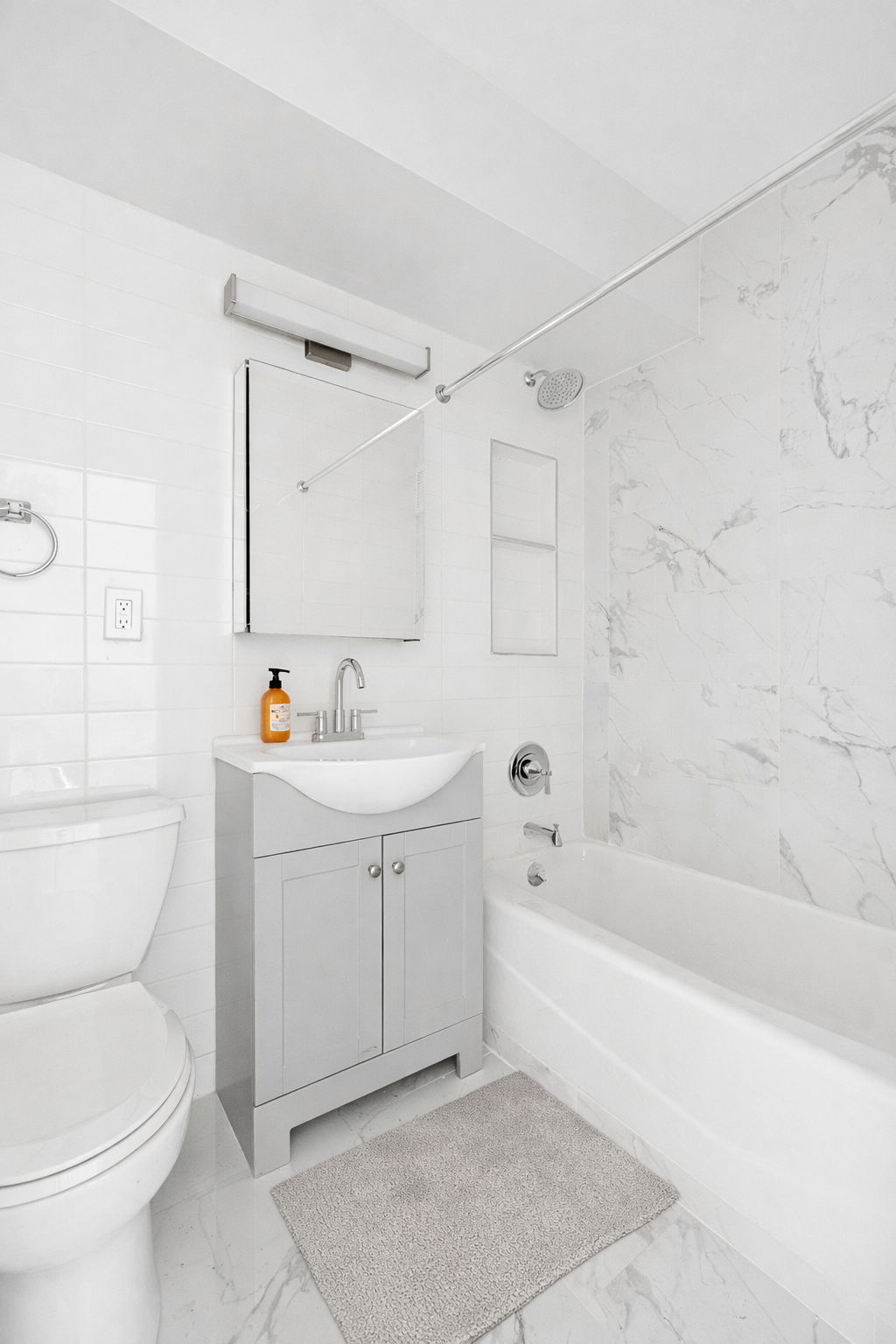 175 Willoughby Street, Unit 5K Brooklyn, NY 11201 - Photo 7 of 15 a bathroom with a sink a toilet and a bathtub