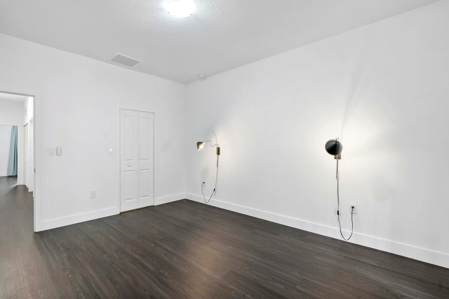 a view of a room with wooden floor