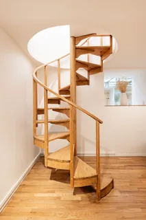 a view of a room with wooden floor and windows