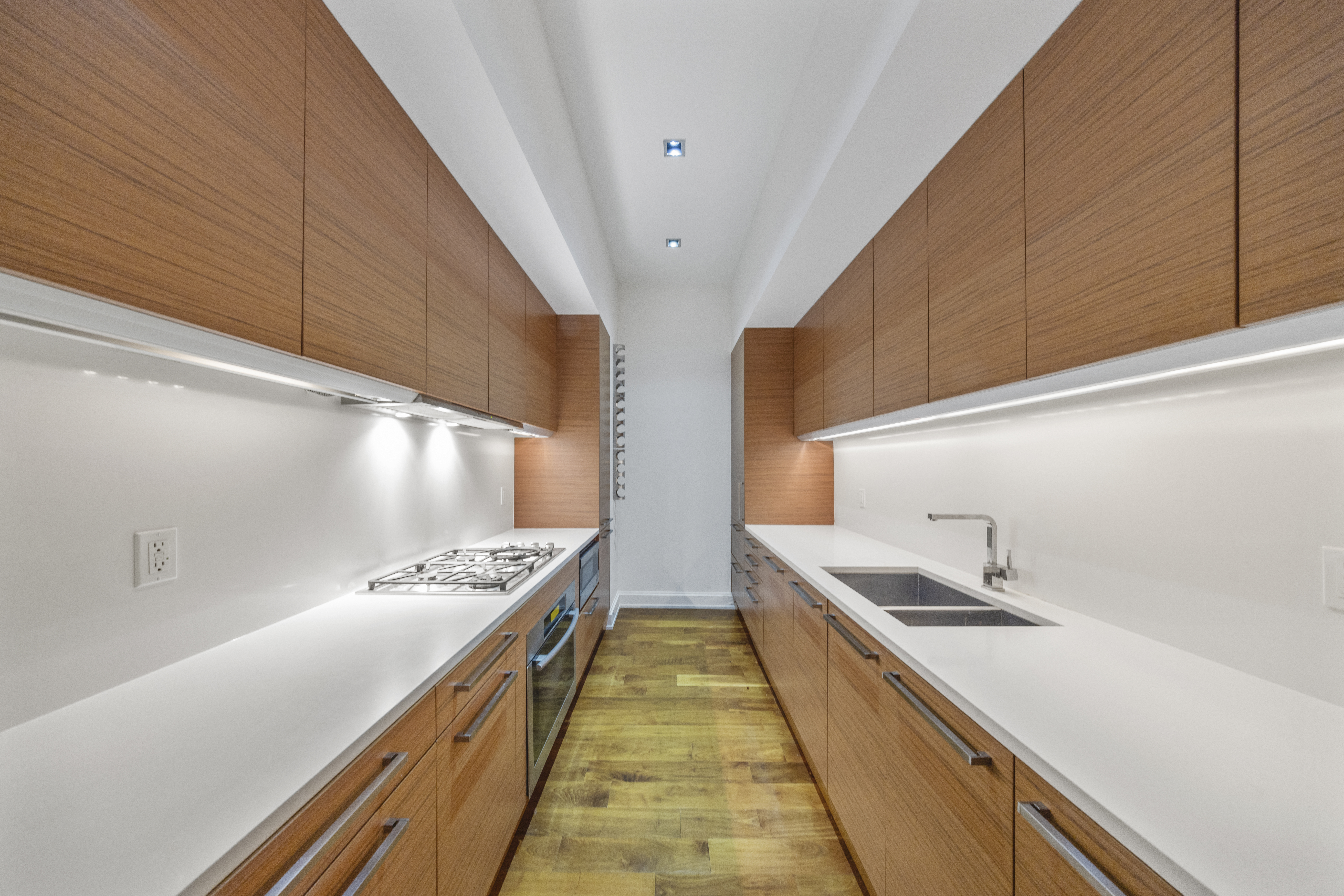 140 West 22nd Street, Unit 2D Manhattan, NY 10011 - Photo 3 of 11 a kitchen with stainless steel appliances sink stove and cabinets