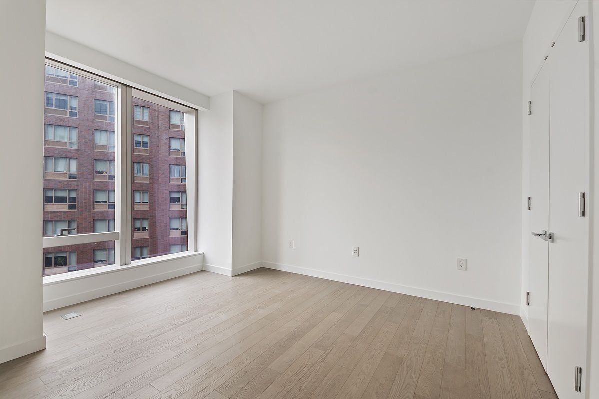 252 South Street, Unit 9J Manhattan, NY 10002 - Photo 3 of 19 a view of an empty room with a window