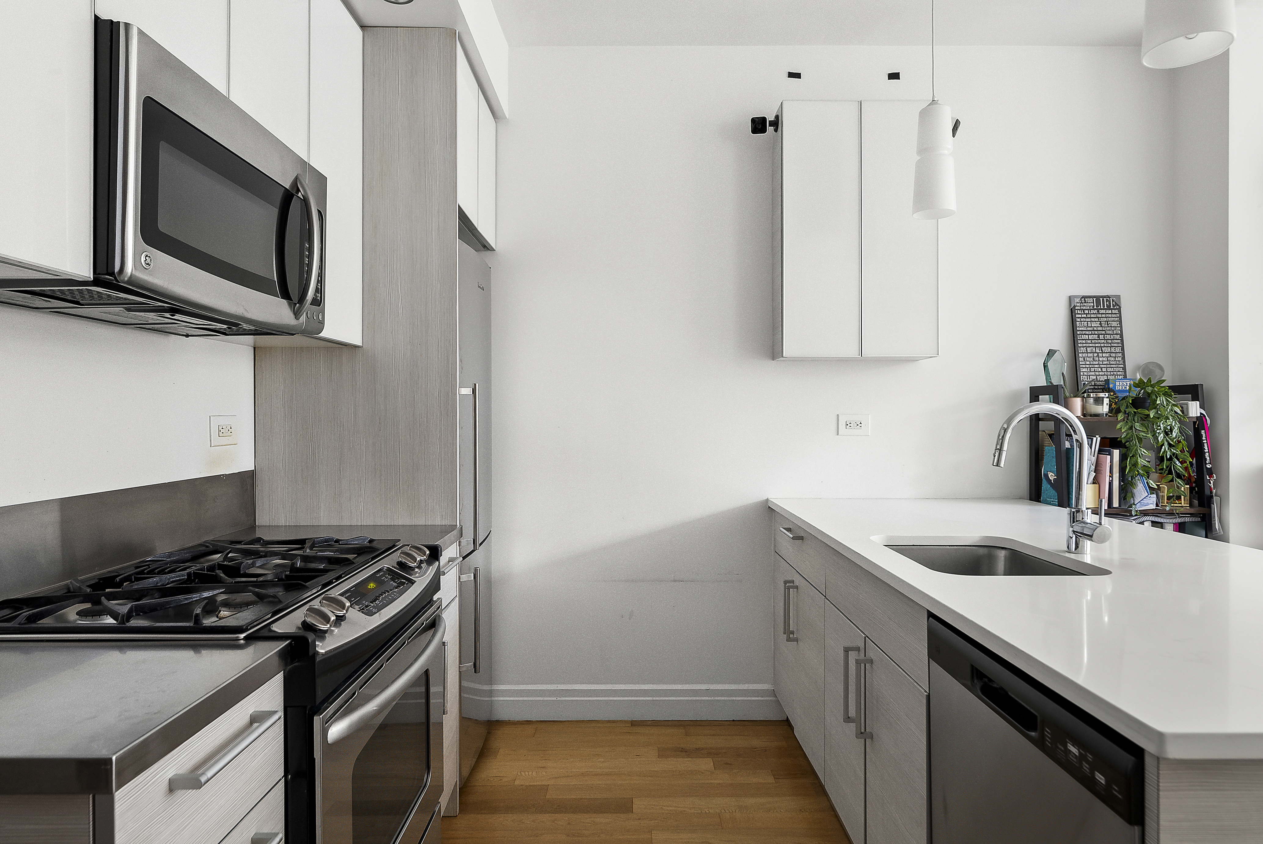 550 West 54th Street, Unit 1030 Manhattan, NY 10019 - Photo 3 of 5 a kitchen that has a sink and a stove
