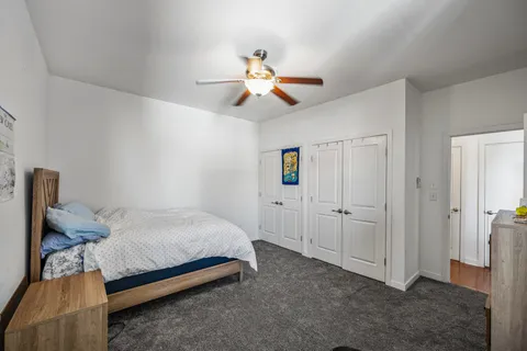 a bedroom with a bed and a chandelier