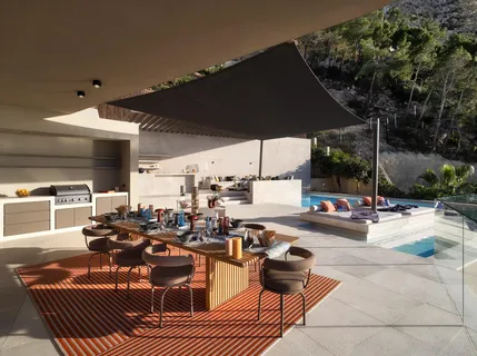 a view of a patio with table and chairs under an umbrella