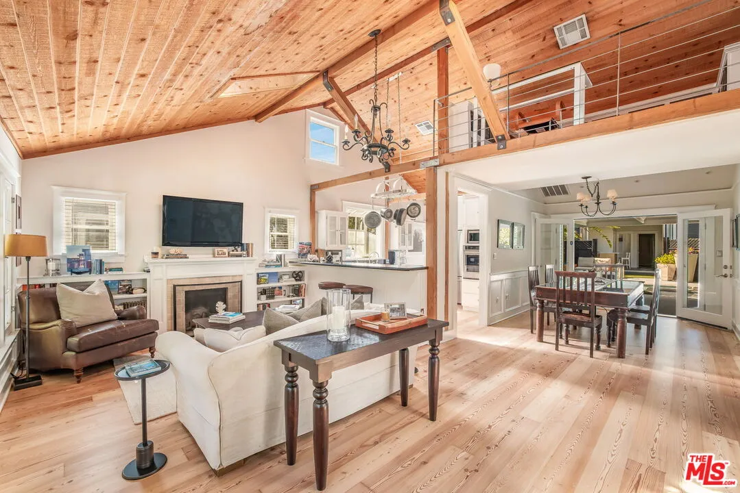 a living room with fireplace furniture and a flat screen tv