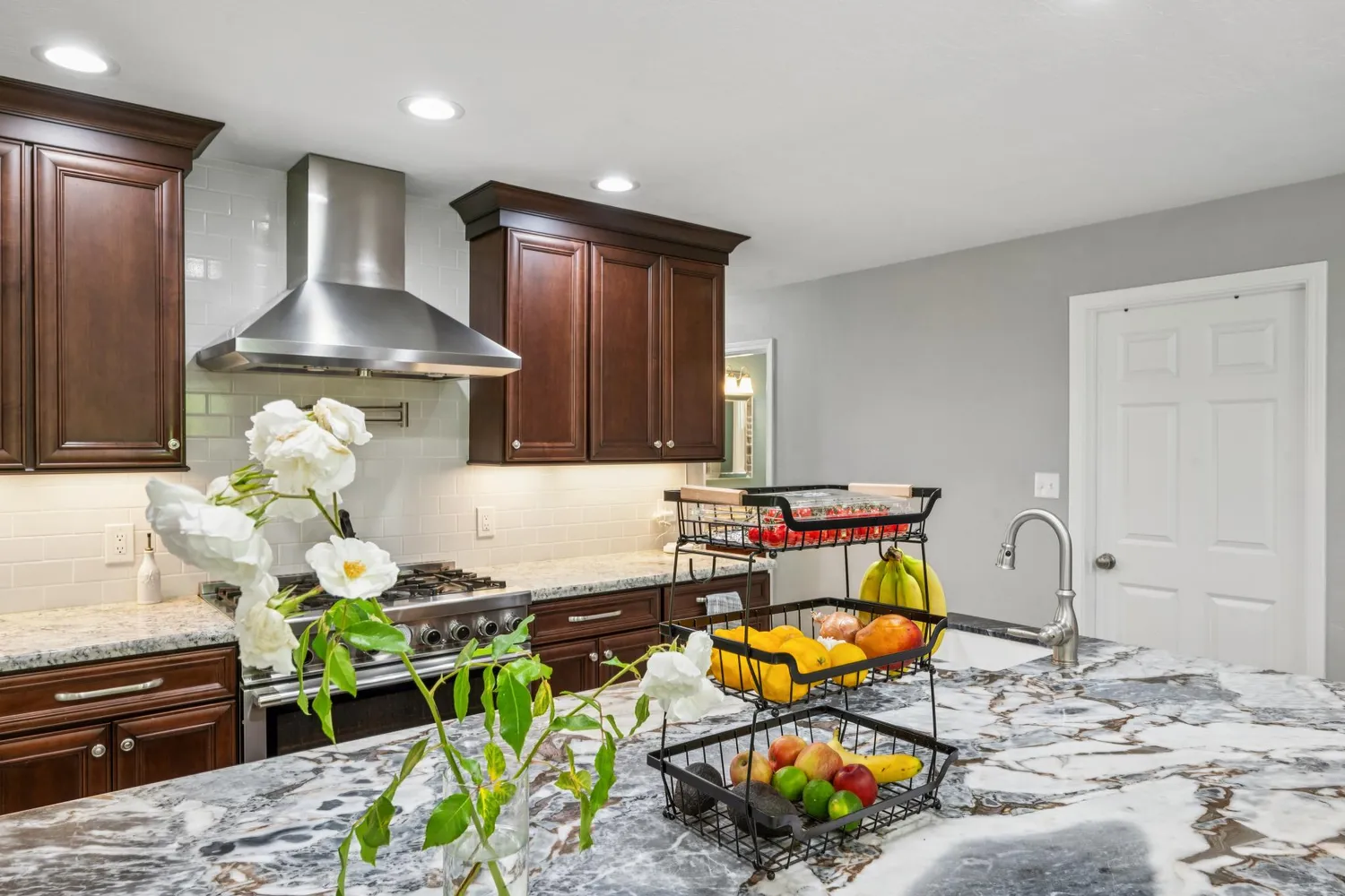 a bedroom with a bed and large windows
