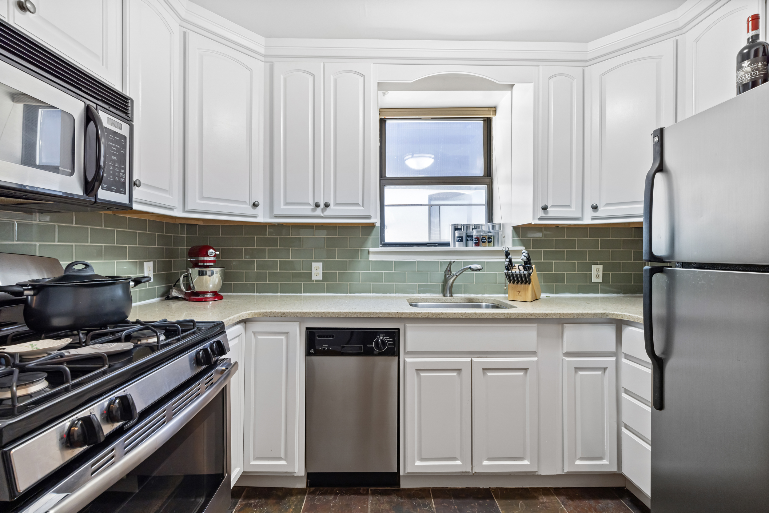 4 West 109th Street, Unit 6A Manhattan, NY 10025 - Photo 4 of 10 a kitchen with cabinets appliances and a window