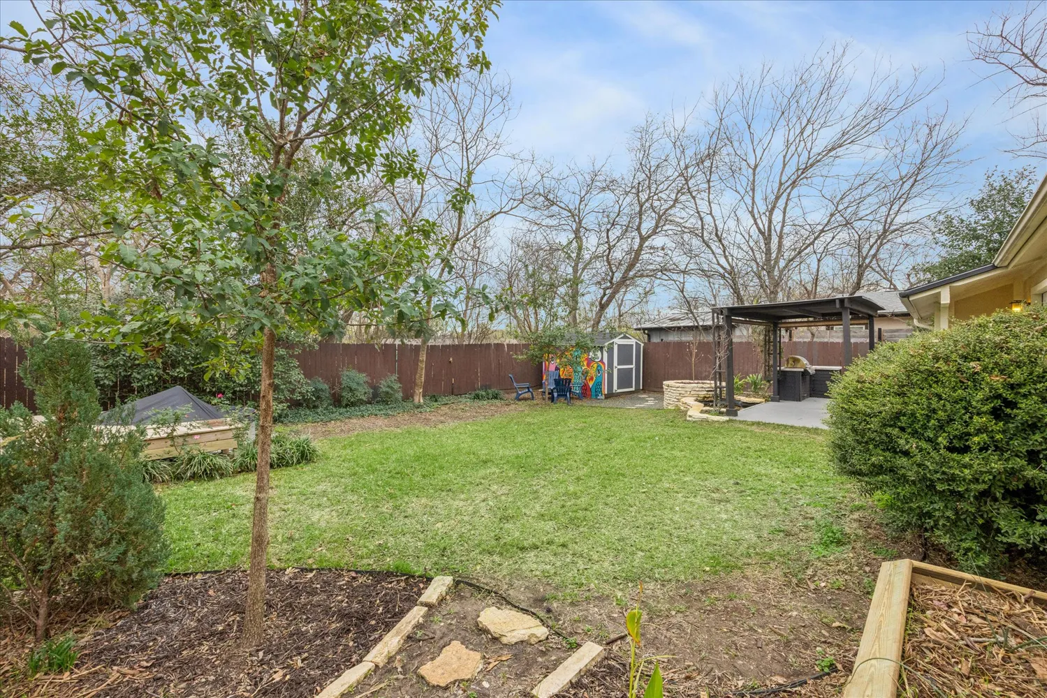 a view of a yard with a house and a large tree