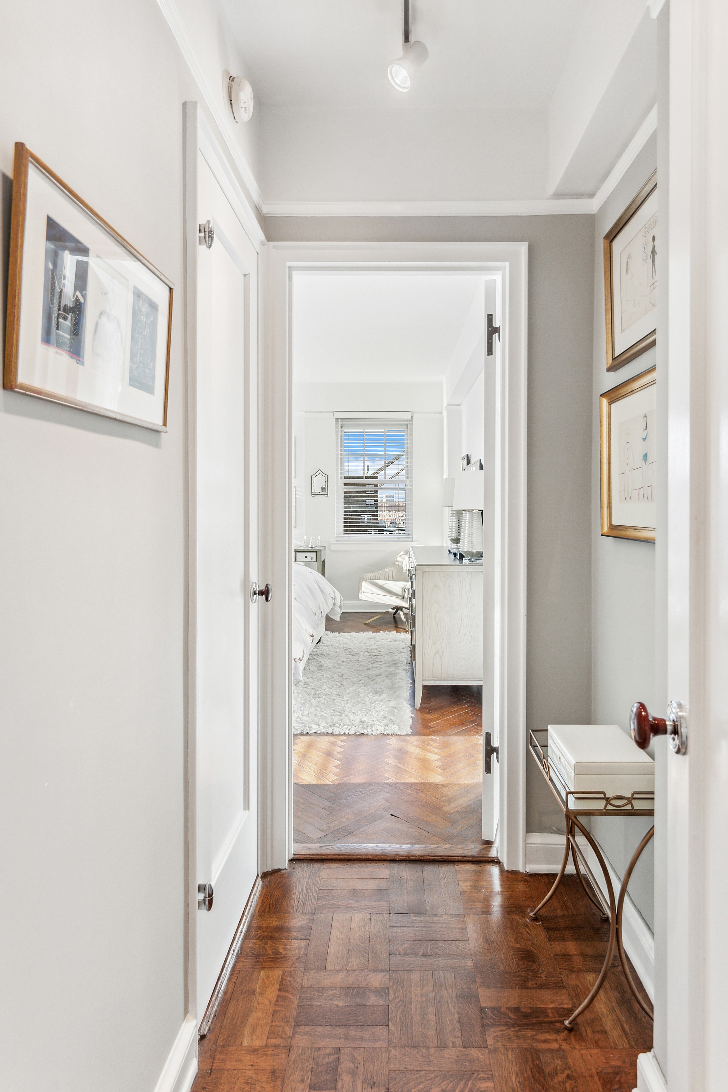 140 Cabrini Boulevard, Unit 92 Manhattan, NY 10033 - Photo 9 of 22 a view of a hallway with bathroom and wooden floor