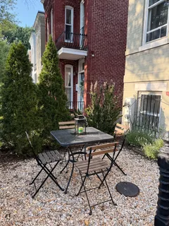 a view of a patio with table and chairs and potted plants