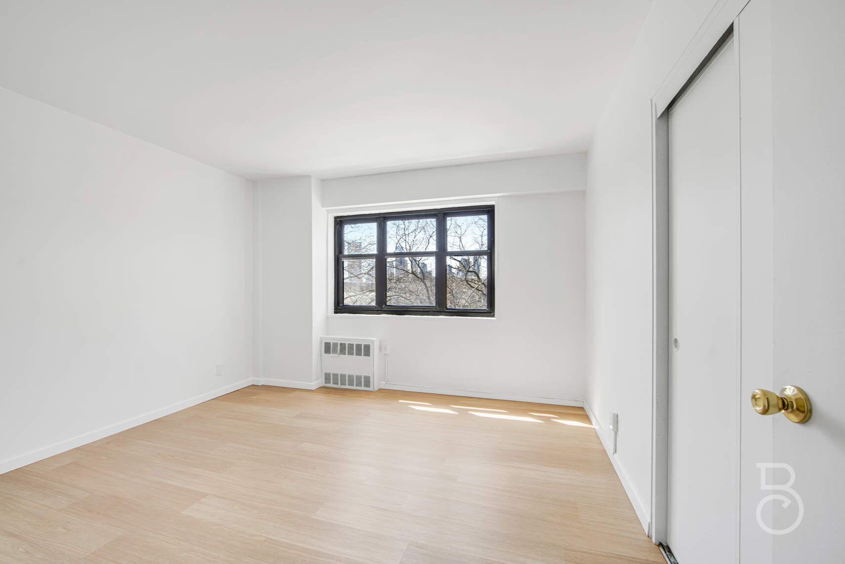 33-65 14th Street, Unit 5D Queens, NY 11106 - Photo 8 of 11 an empty room with windows