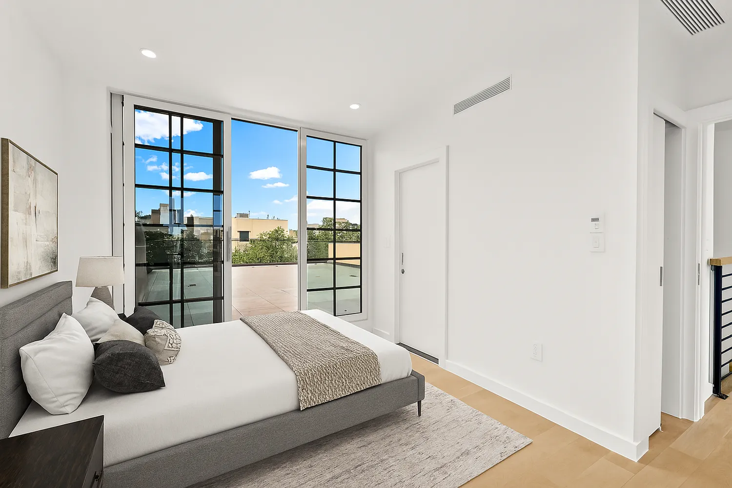 a bedroom with a large bed and a large window