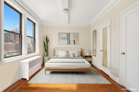 a bedroom with a bed and a large window