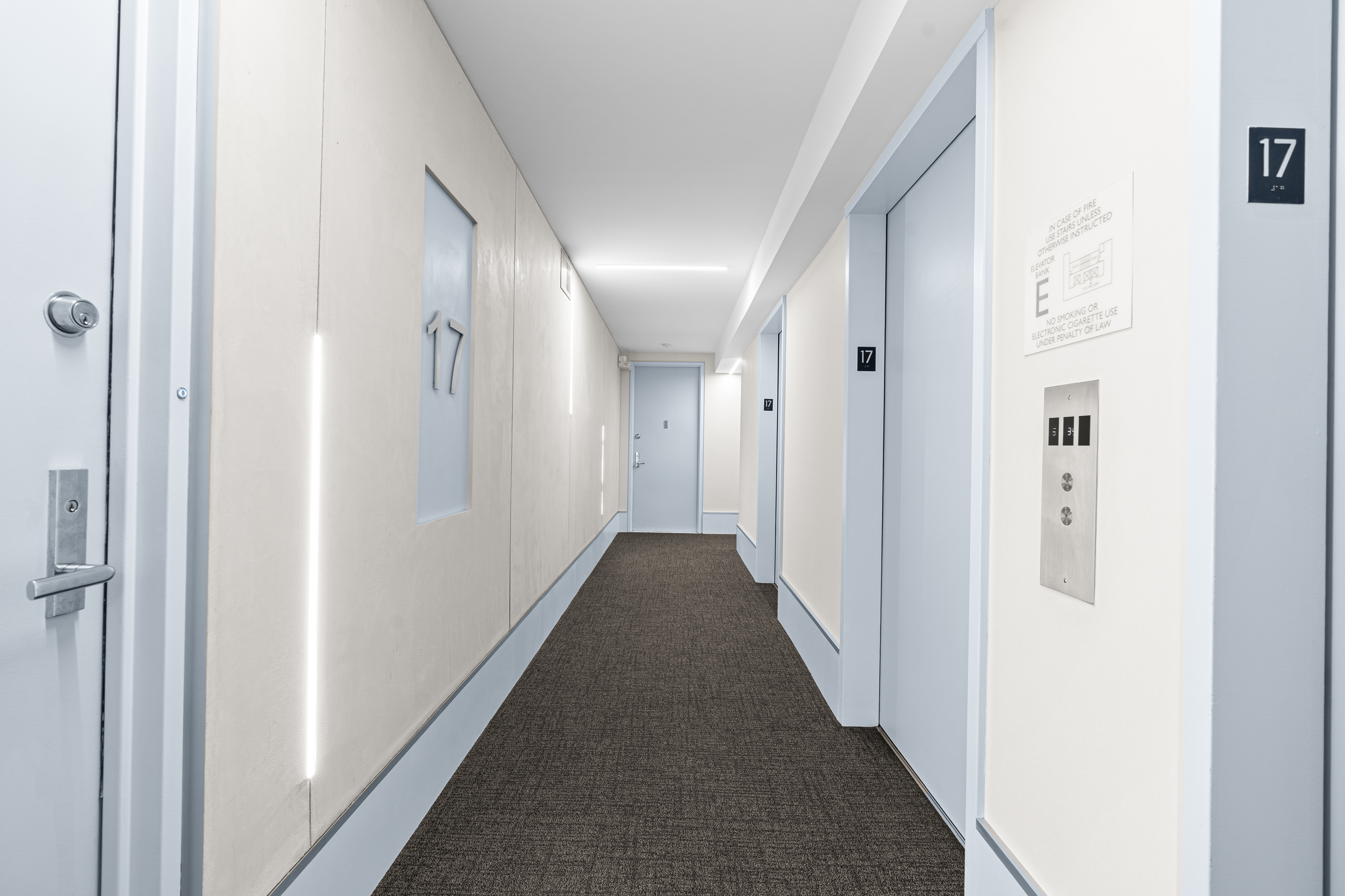 236 East 47th Street, Unit 17C Manhattan, NY 10017 - Photo 8 of 11 a view of a hallway with a white walls
