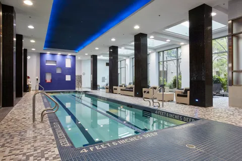 a view of a swimming pool and outdoor kitchen