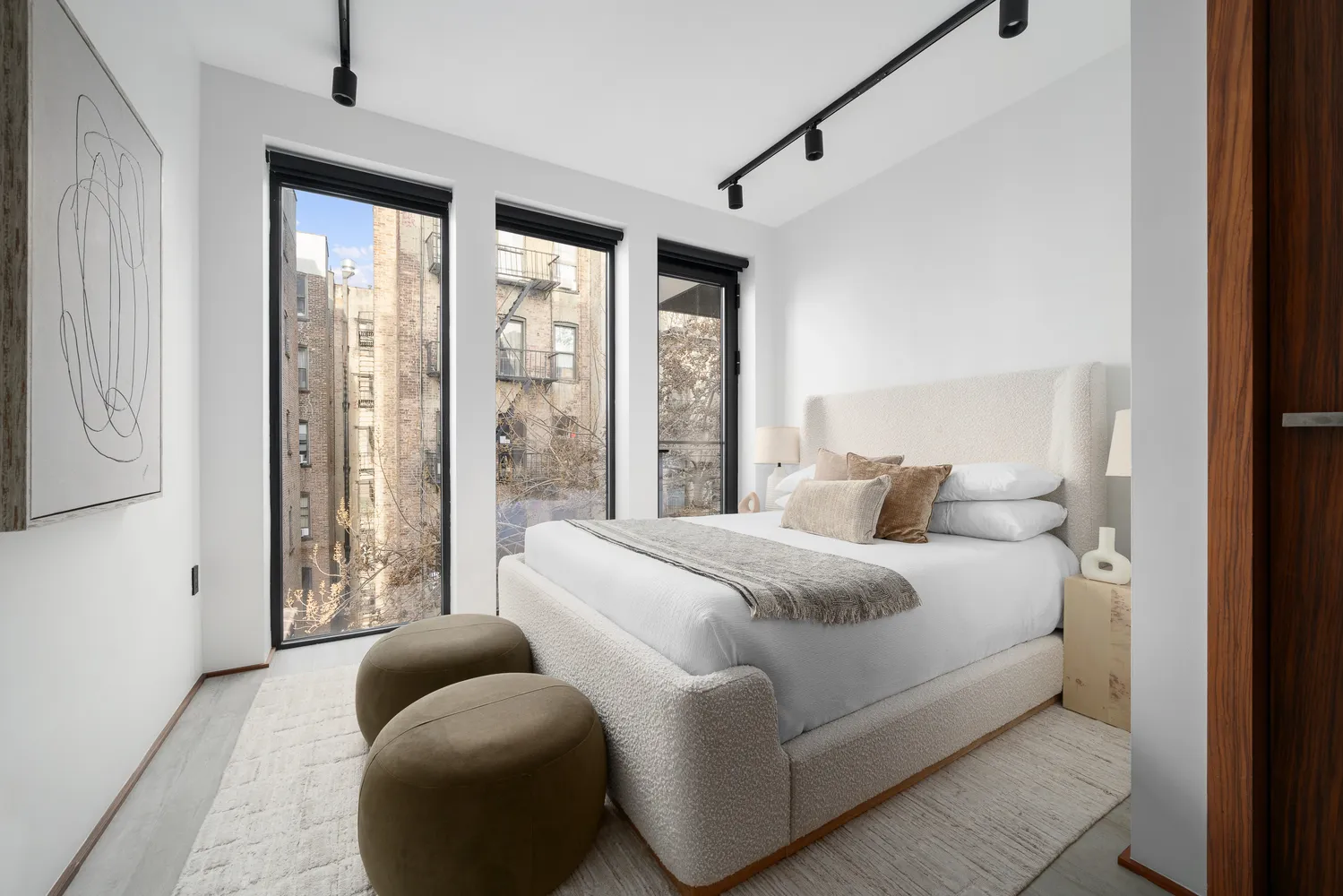 a bedroom with a bed and glass windows