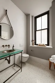 a bathroom with a toilet a sink and a mirror