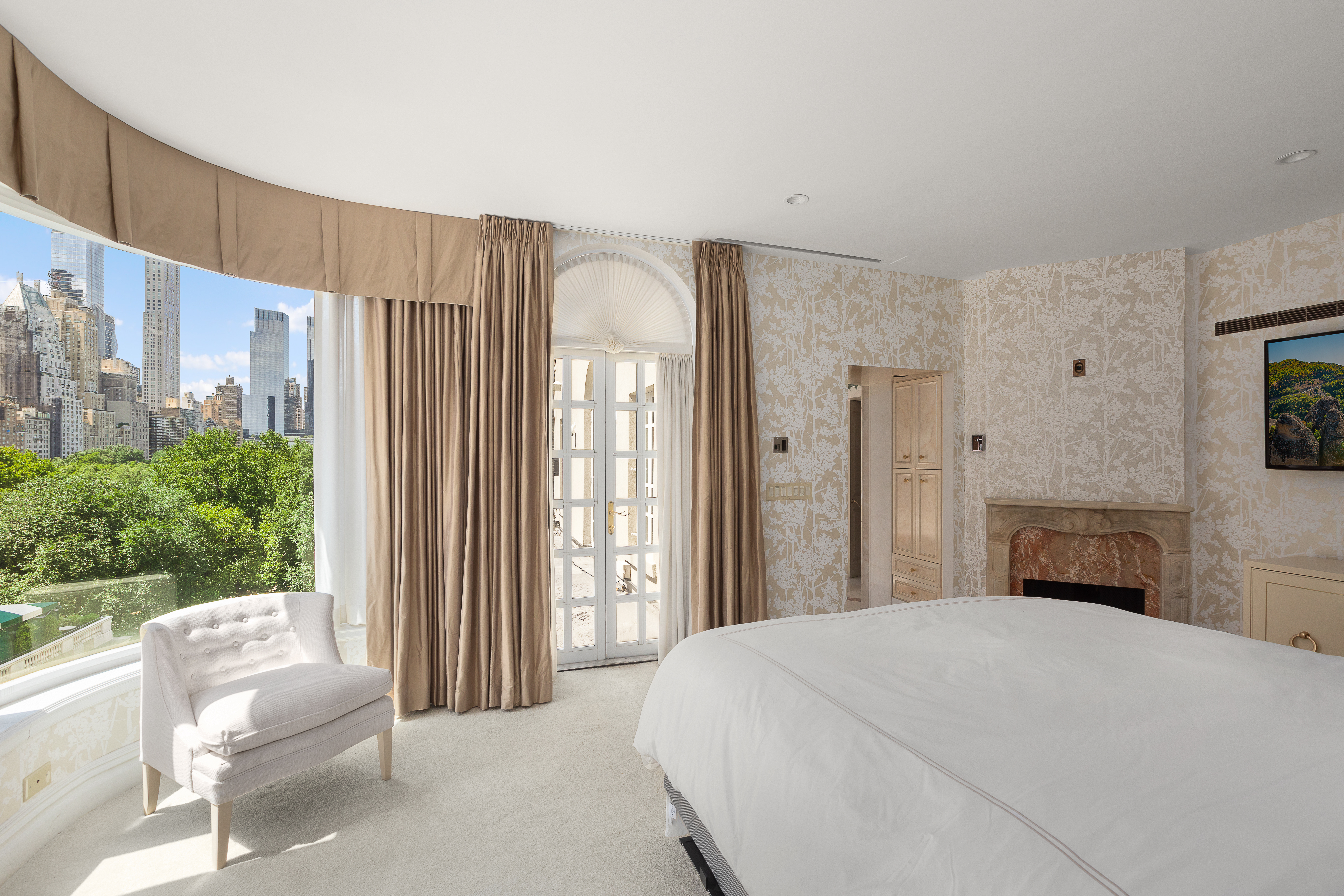 1 East 62nd Street, Unit PH Manhattan, NY 10065 - Photo 7 of 13 a bedroom with a bed and a large window