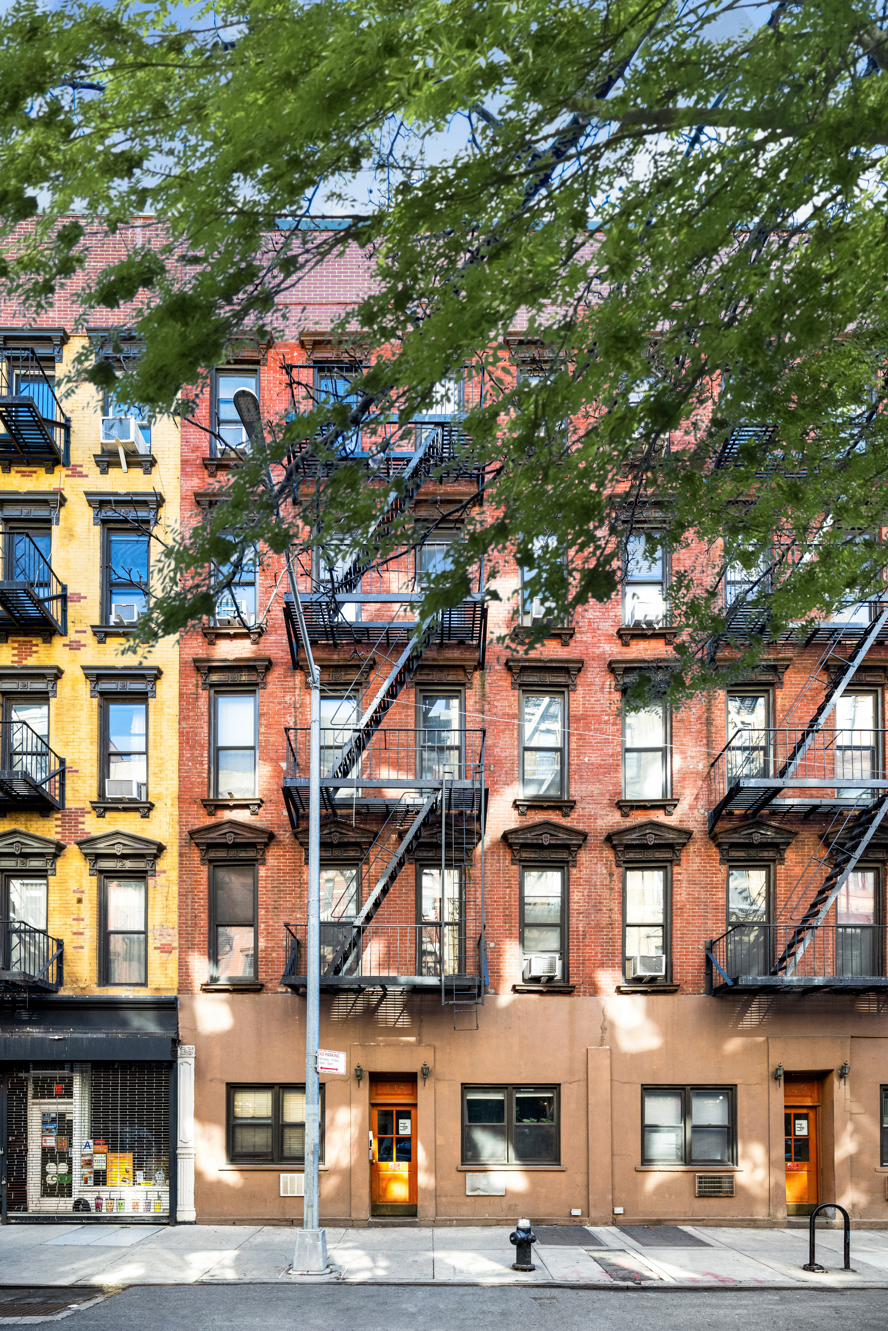 143 Sullivan Street, Unit 12 Manhattan, NY 10012 - Photo 11 of 11 a view of a building with a tree