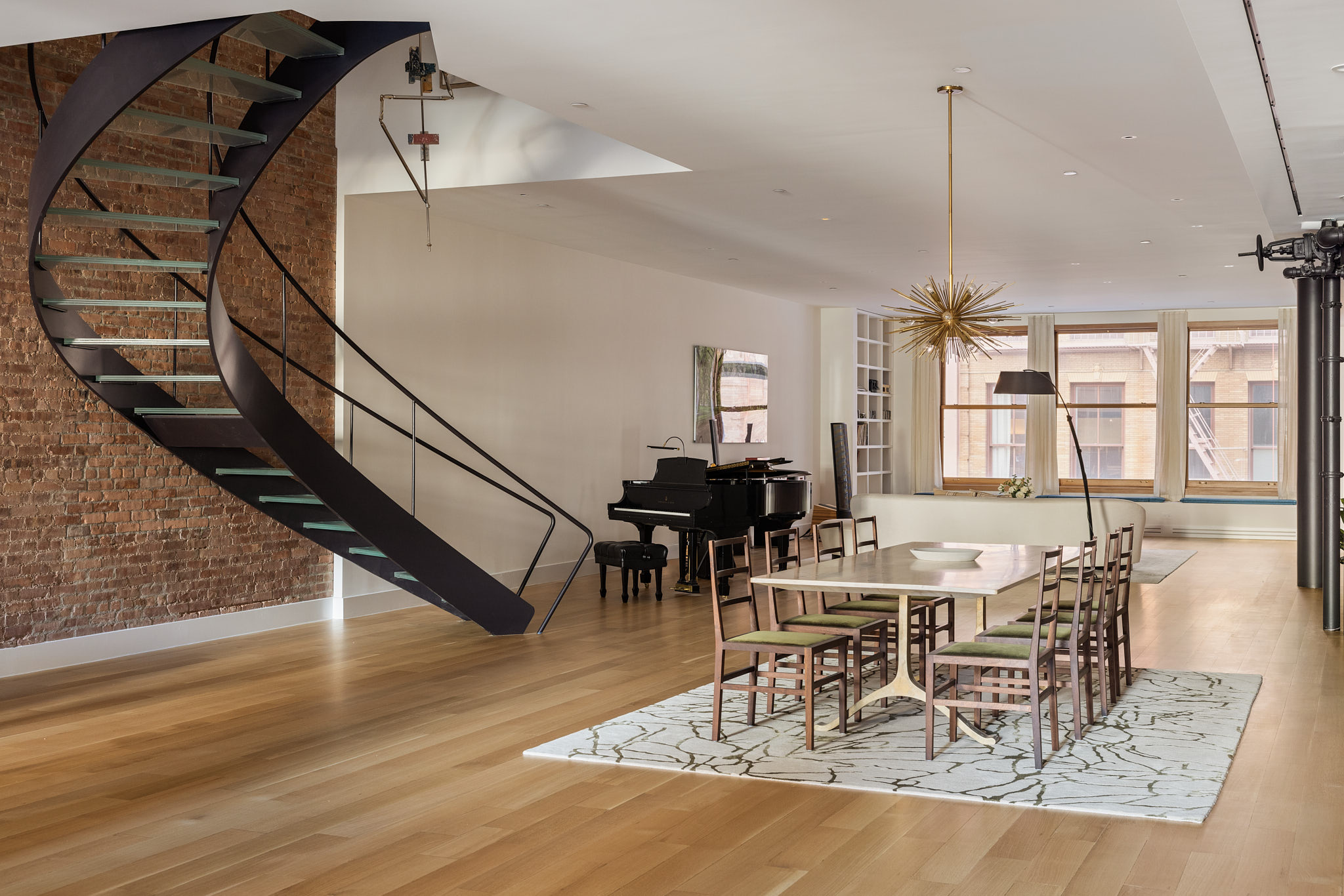 101 Wooster Street, Unit 3F/4F Manhattan, NY 10012 - Photo 3 of 24 a view of a dining room and livingroom with furniture wooden floor a chandelier