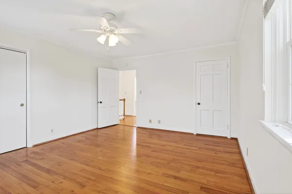 a view of an empty room with wooden floor