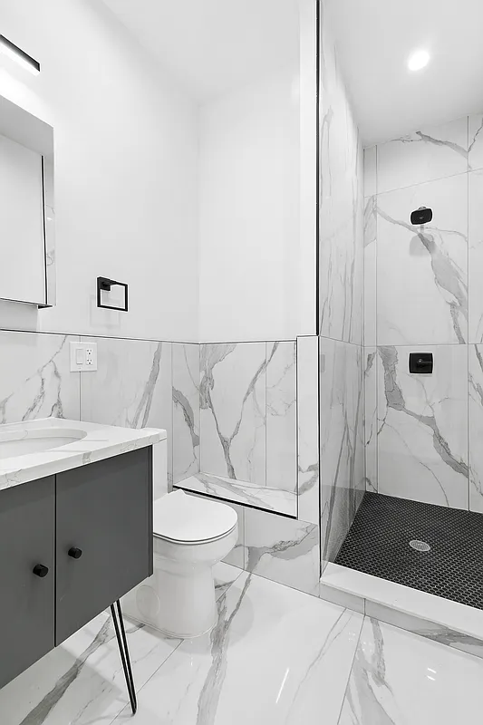 162 Cornelia Street, Unit 3 Brooklyn, NY 11221 - Photo 7 of 9 a bathroom with a sink a toilet and shower