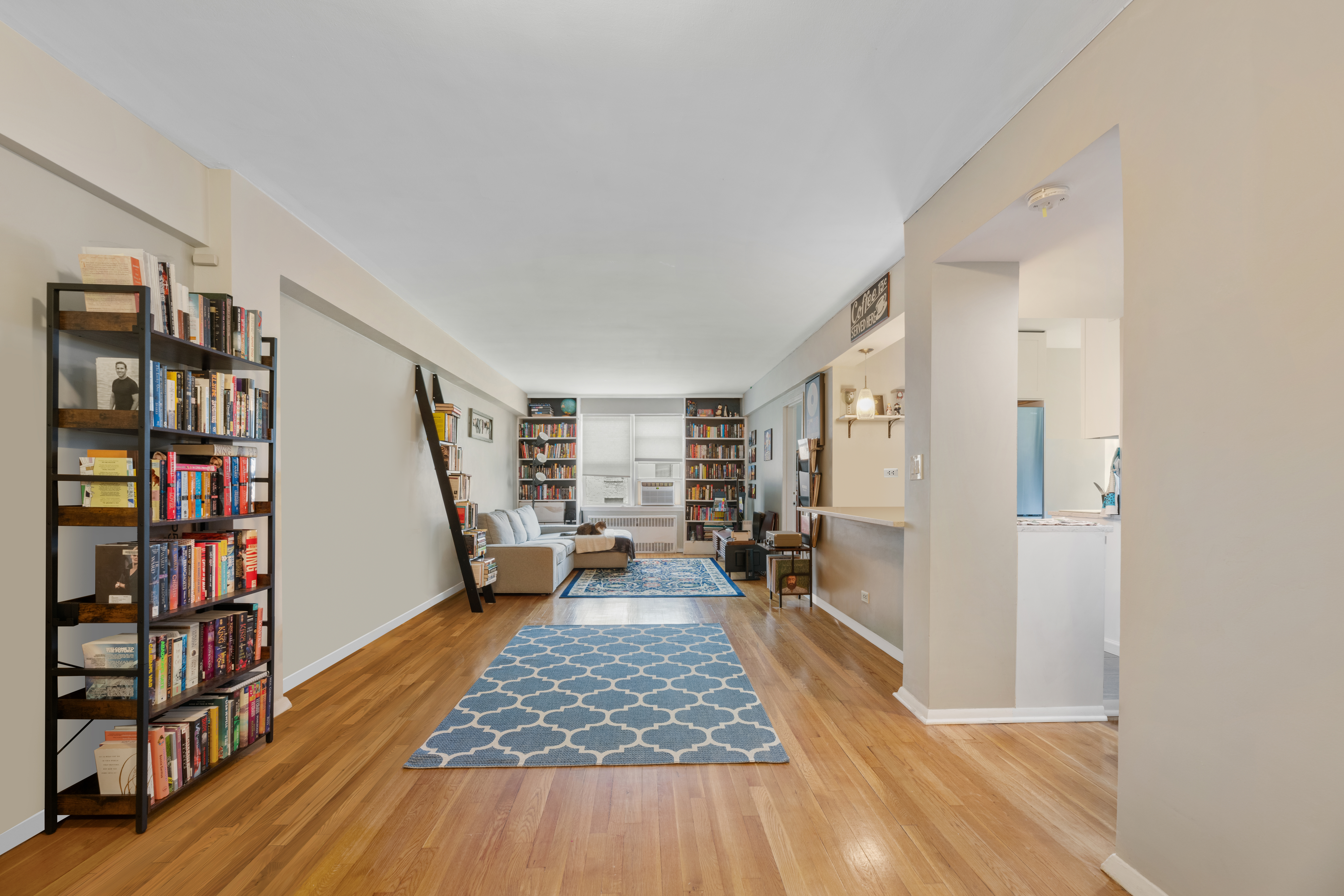800 Grand Concourse, Unit 5JN Bronx, NY 10451 - Photo 2 of 7 a living room with furniture and a wooden floor
