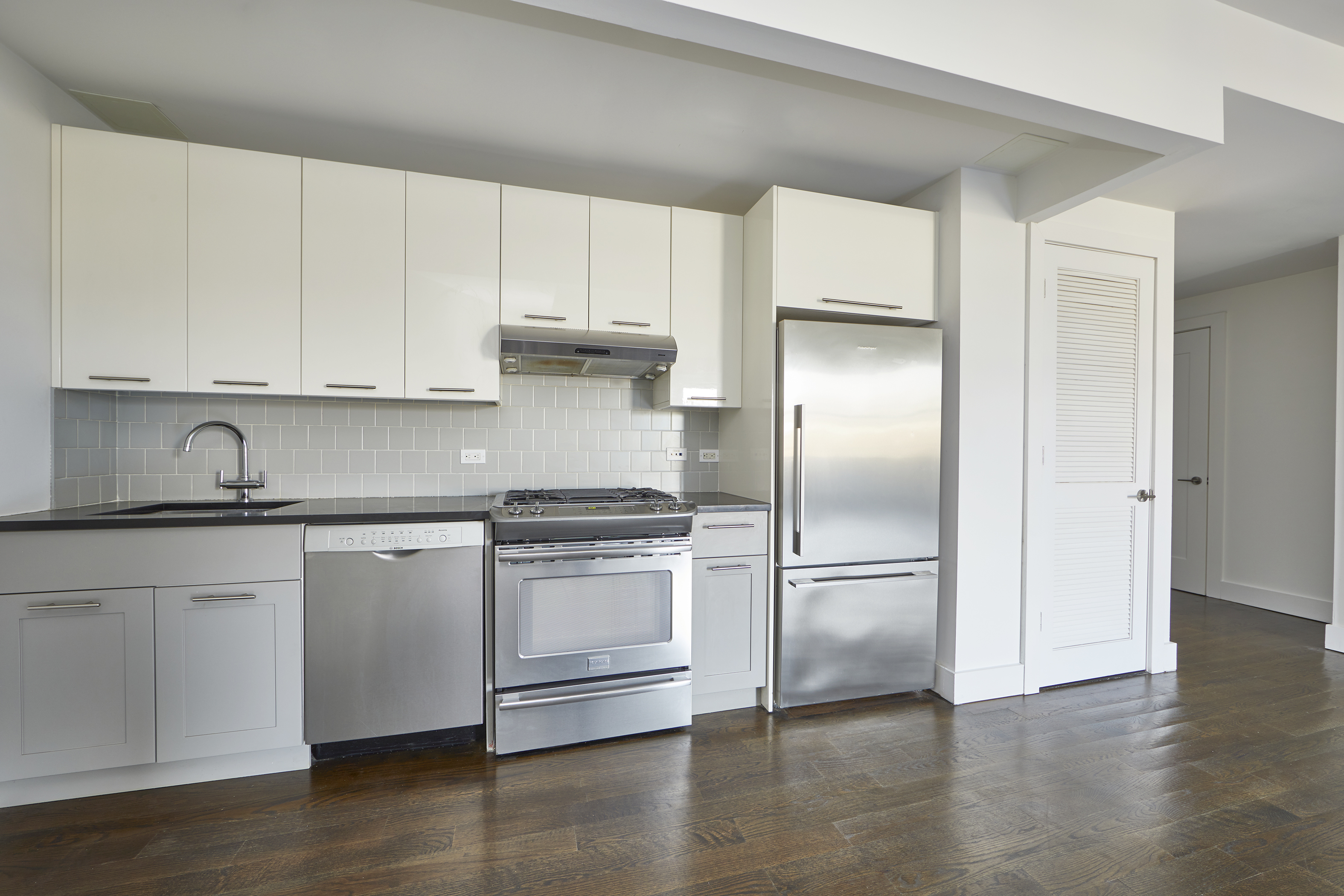 341 Eastern Parkway, Unit 8D Brooklyn, NY 11216 - Photo 2 of 7 a kitchen with granite countertop a refrigerator sink and cabinets