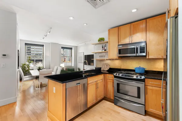 a kitchen with a sink stove and microwave