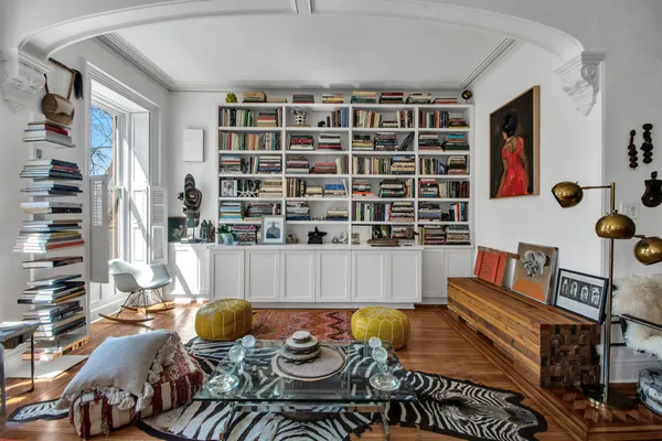 a living room with furniture and a book shelf