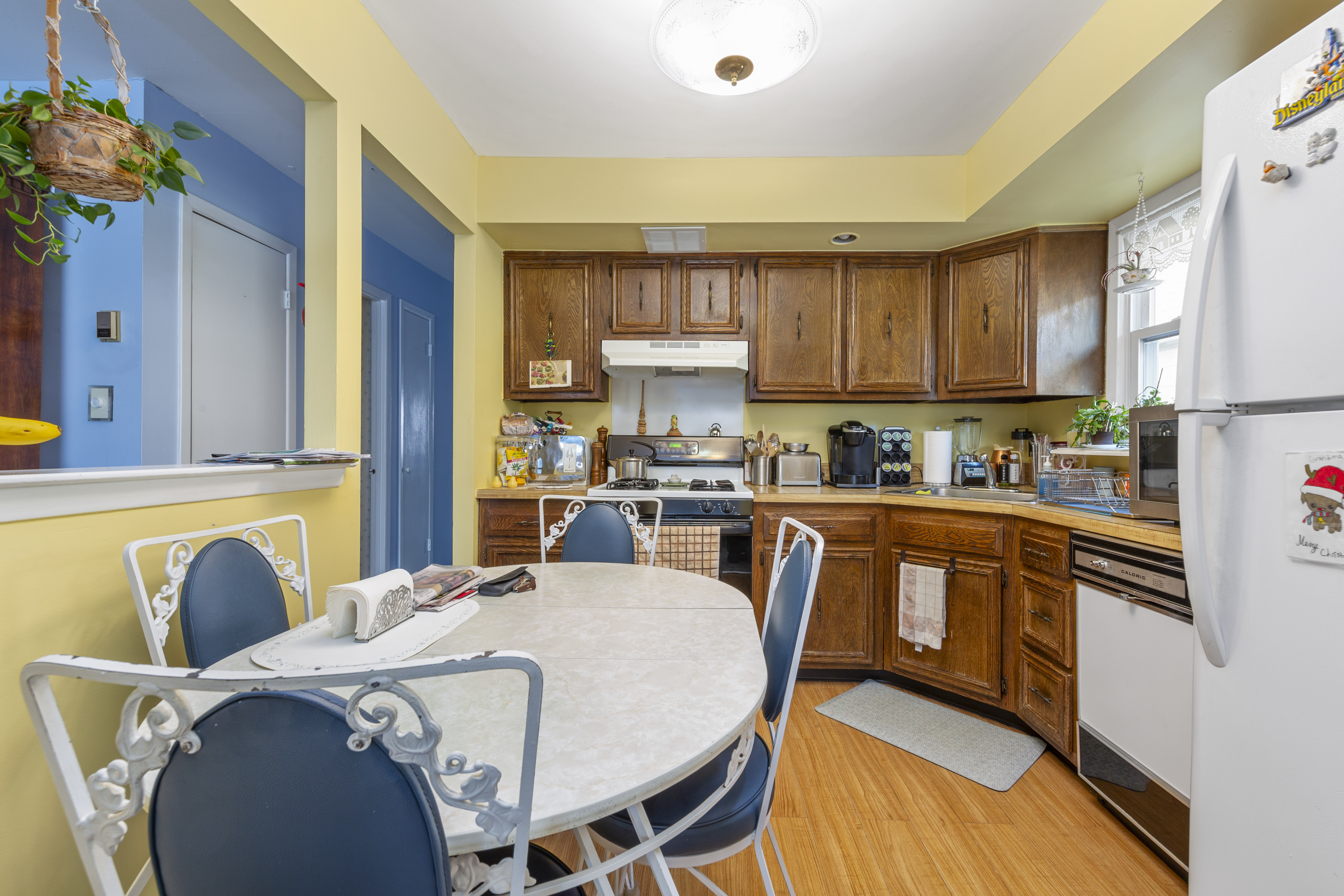 240-47 68th Avenue Queens, NY 11362 - Photo 16 of 39 a kitchen with stainless steel appliances granite countertop a refrigerator a sink a stove and white cabinets