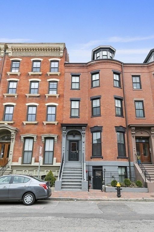 a front view of a residential apartment building with a yard