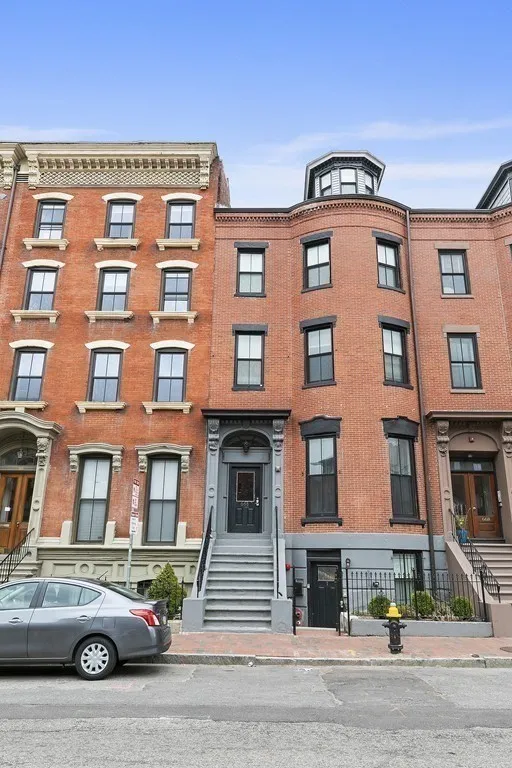 a front view of a residential apartment building with a yard