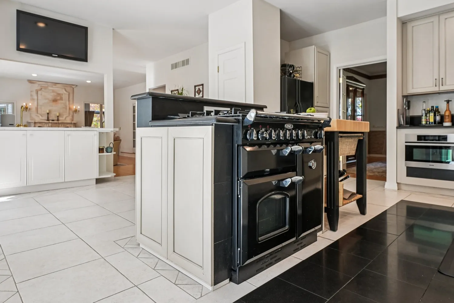 a kitchen with stainless steel appliances granite countertop a stove a refrigerator and a microwave