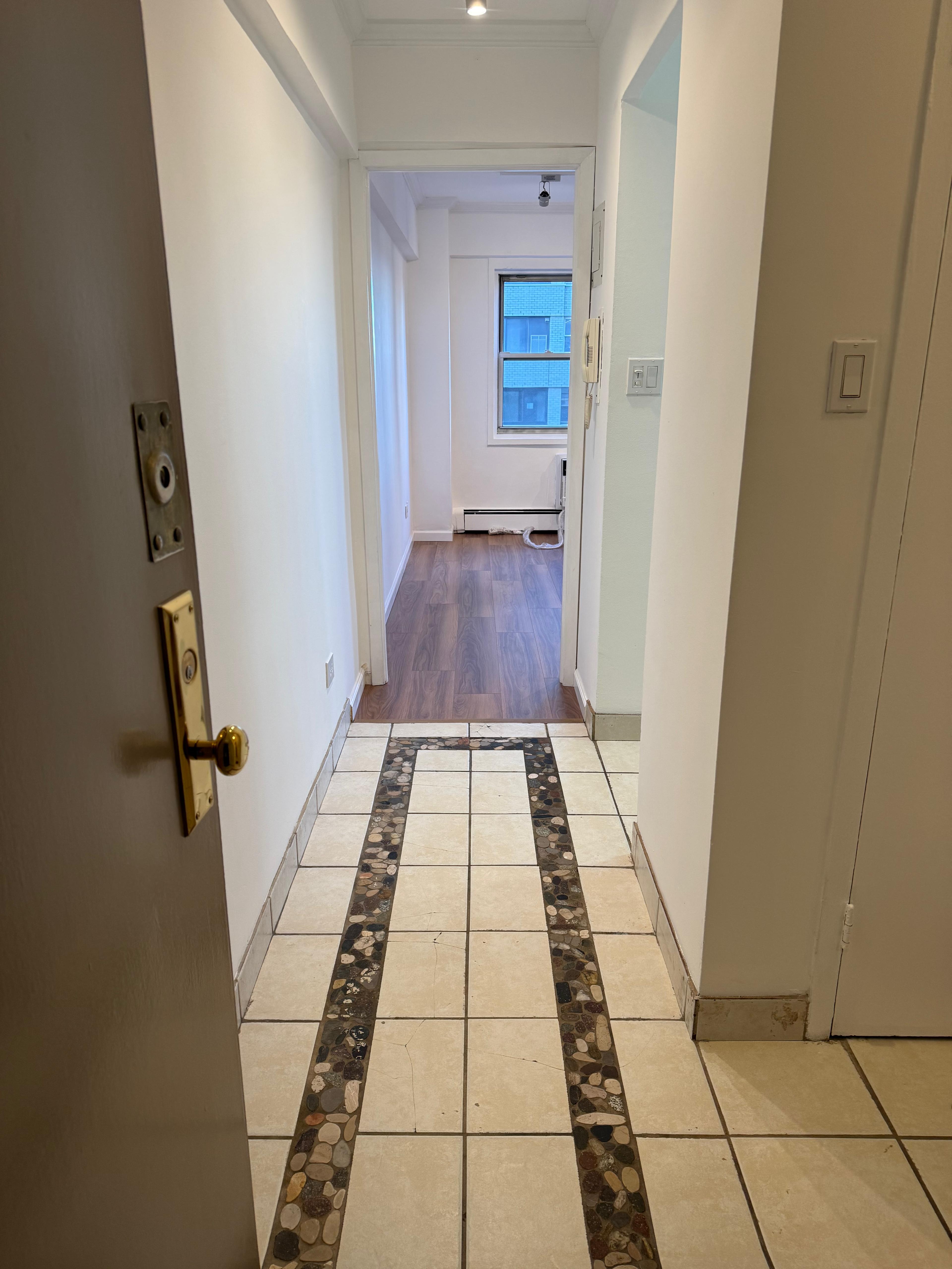 40 Sutton Place, Unit 7A Manhattan, NY 10022 - Photo 10 of 11 a view of an empty room with wooden floor and a carpet