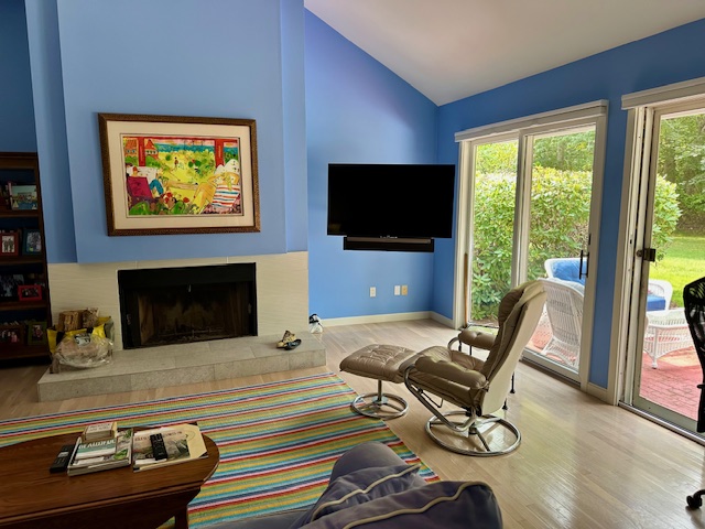 11 Juniper Circle Brewster, MA 02631 - Photo 5 of 29 a living room with furniture a flat screen tv and a floor to ceiling window