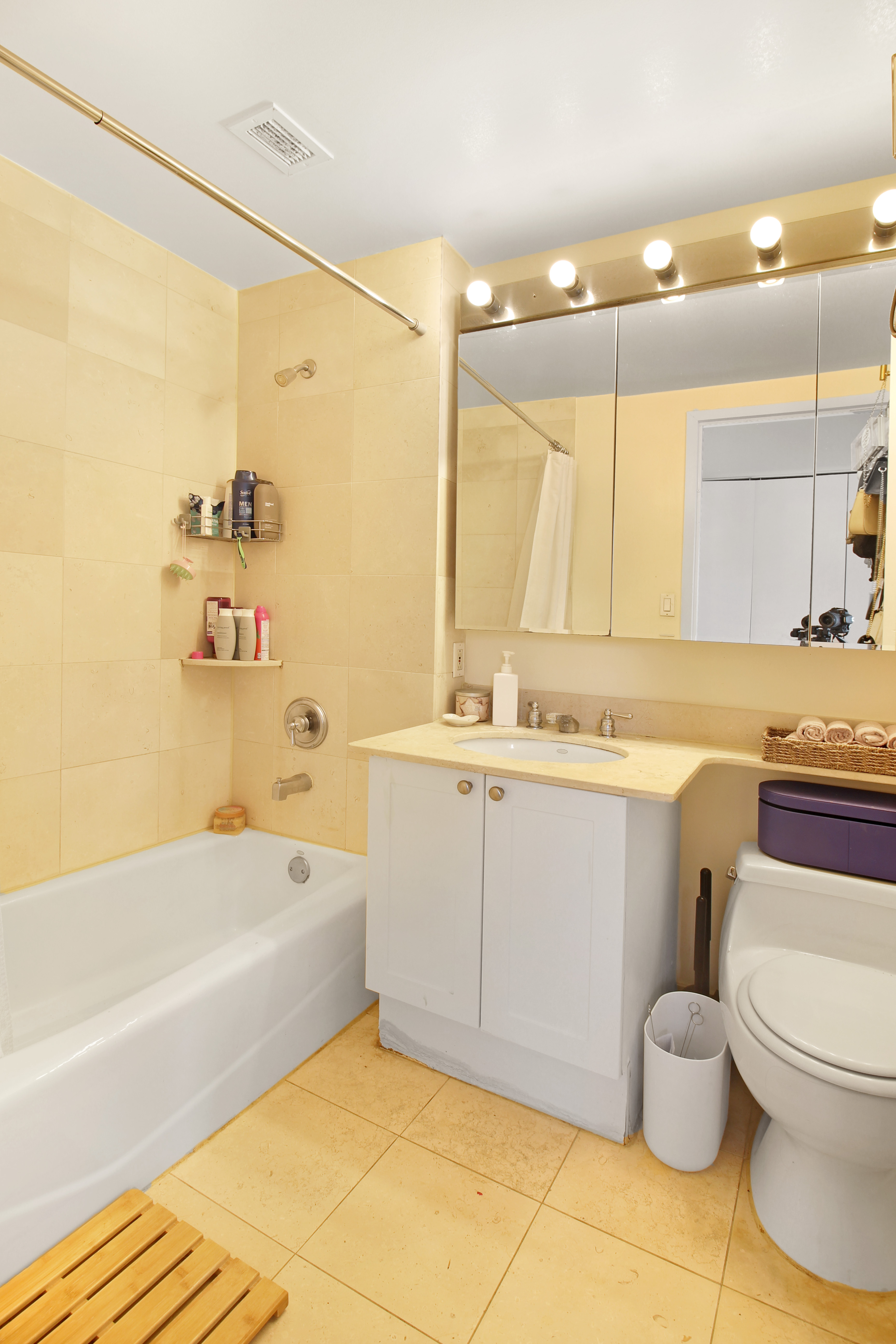 308 East 38th Street, Unit 20A Manhattan, NY 10016 - Photo 8 of 13 a bathroom with a granite countertop bathtub sink vanity mirror and toilet