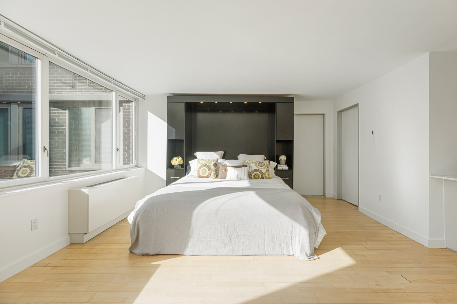 322 West 57th Street, Unit 23P Manhattan, NY 10019 - Photo 3 of 11 a bedroom with a bed and window