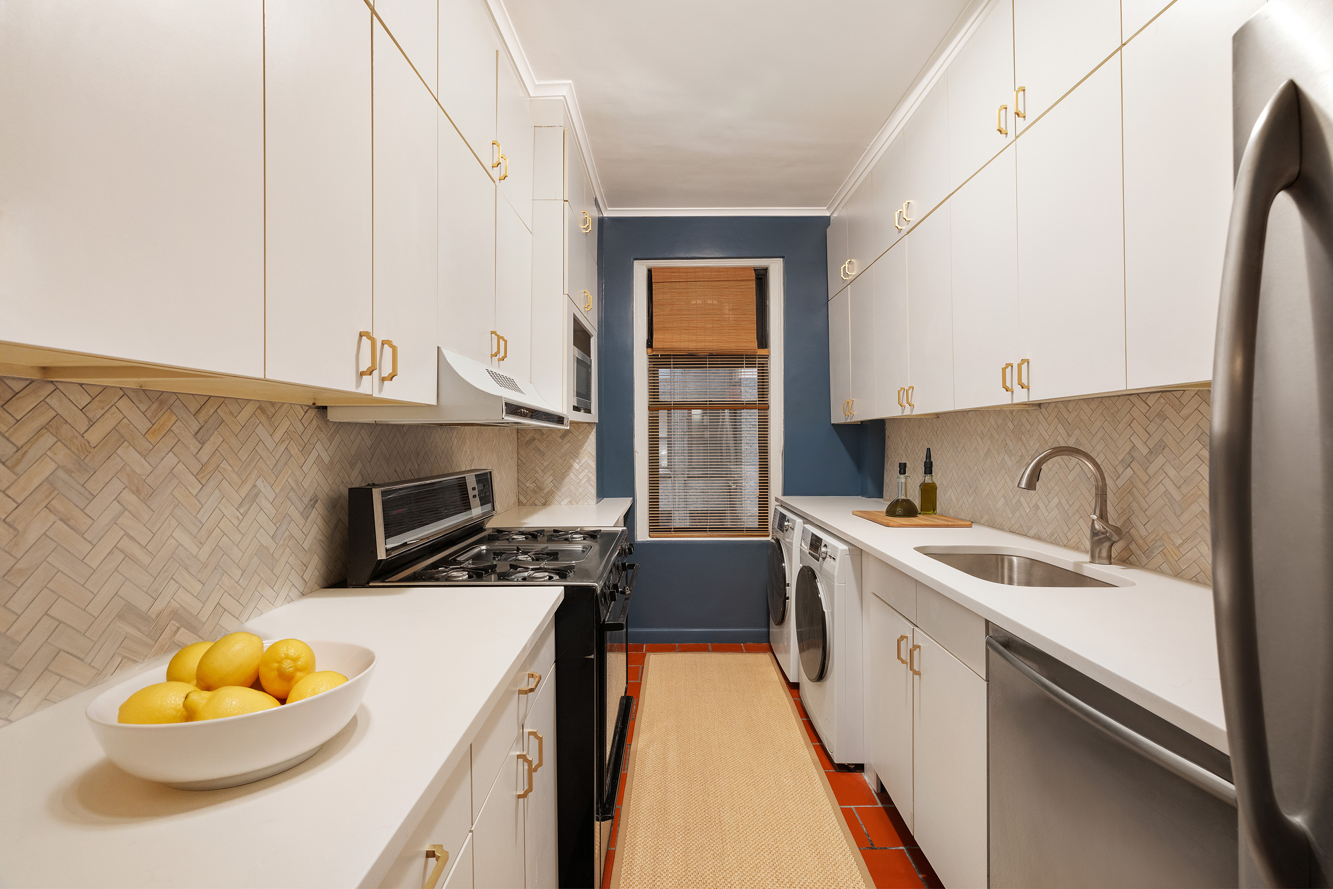 115 East 86th Street, Unit 22 Manhattan, NY 10028 - Photo 6 of 16 a kitchen with a sink a stove and cabinets