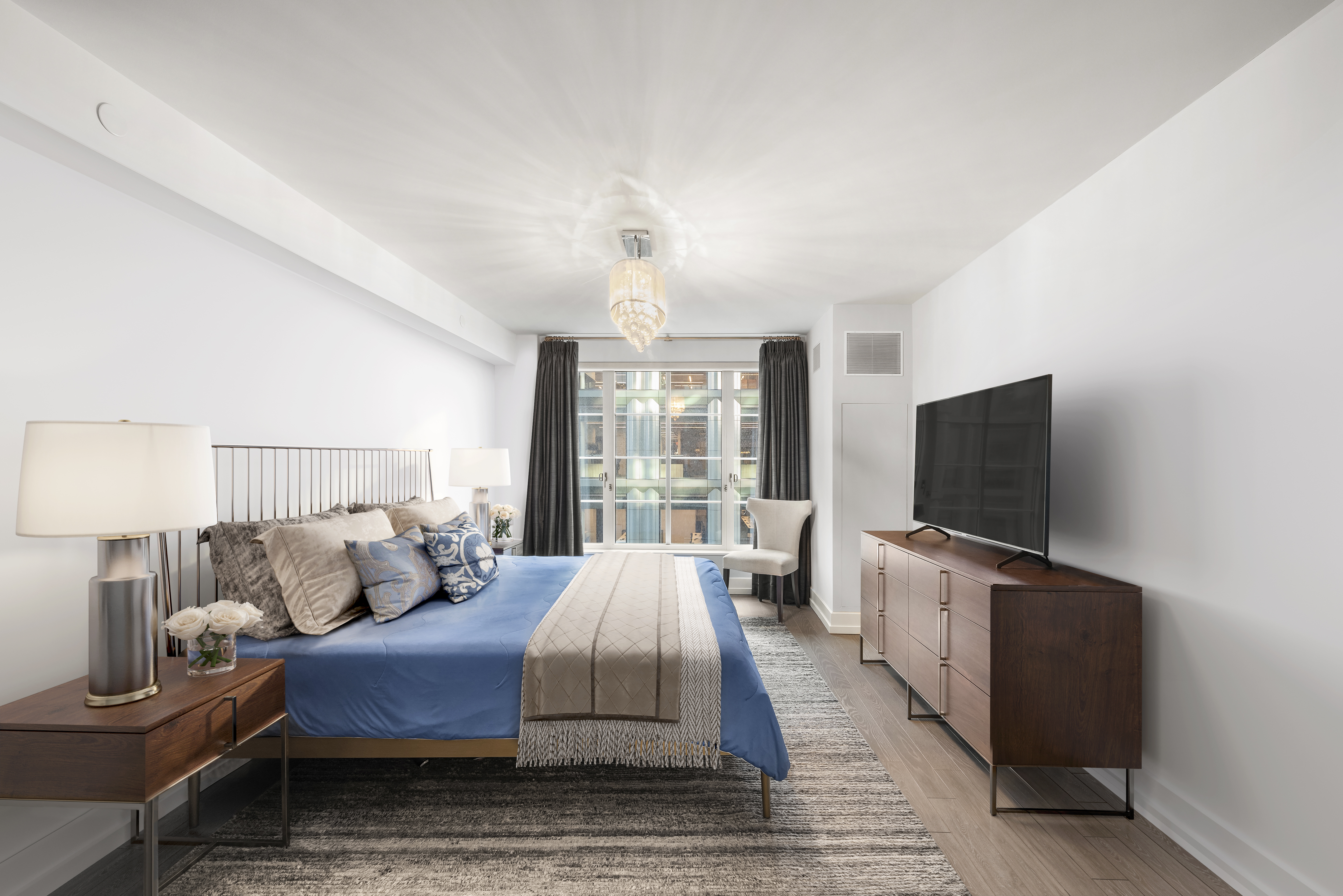 70 Charlton Street, Unit 11A Manhattan, NY 10014 - Photo 9 of 22 a living room with furniture and a flat screen tv