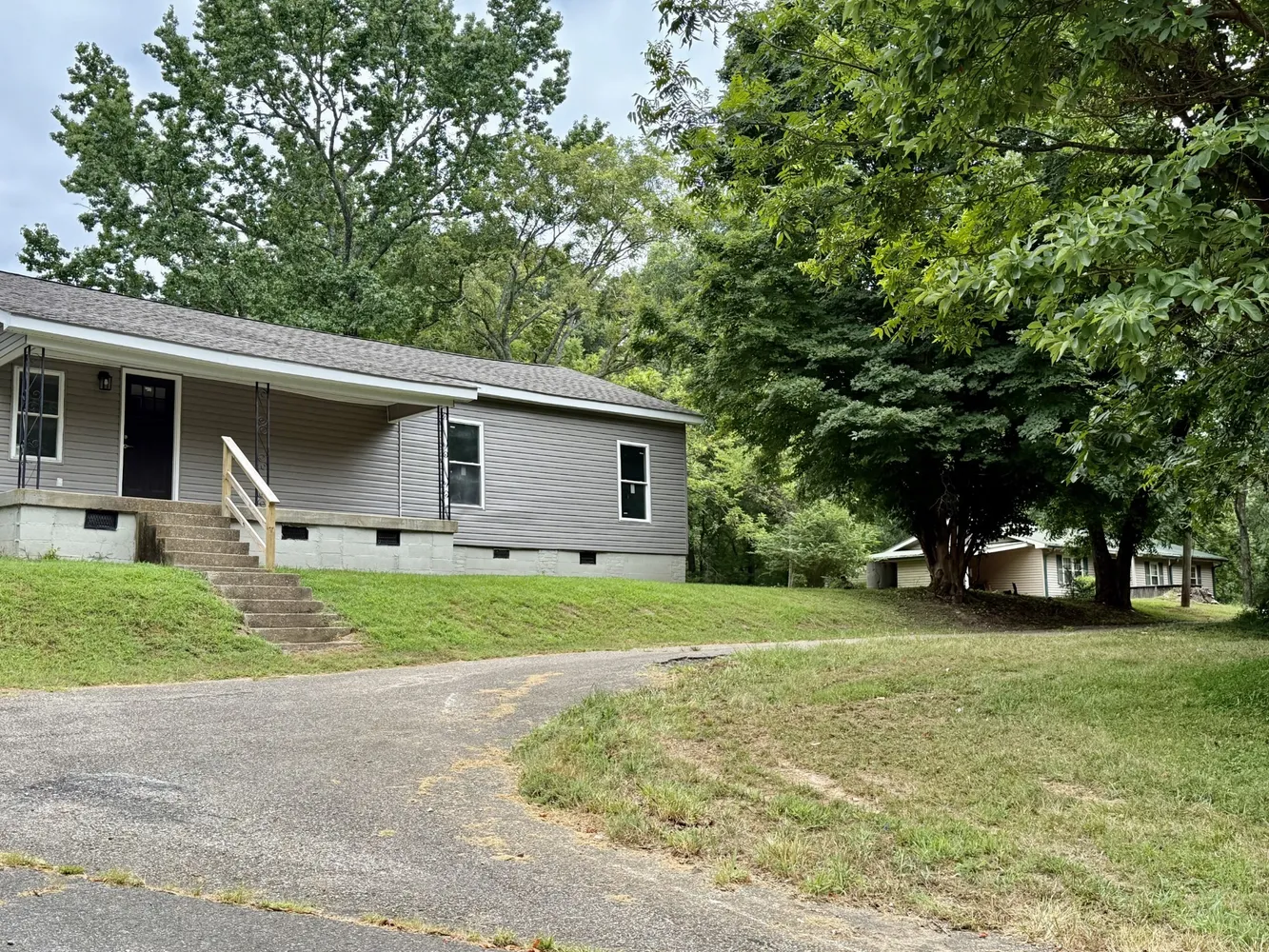 a front view of house with yard and trees