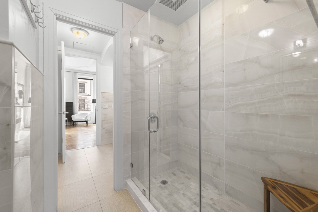 209 East 61st Street Manhattan, NY 10065 - Photo 12 of 27 a bathroom with a shower