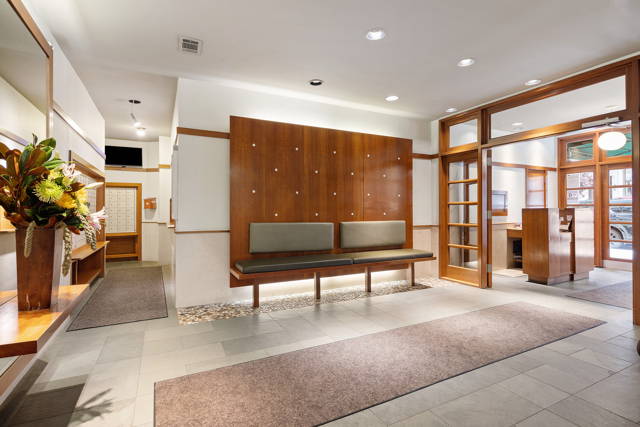 120 East 90th Street, Unit 16E Manhattan, NY 10128 - Photo 13 of 15 a living room with furniture a flat screen tv and floor to ceiling window