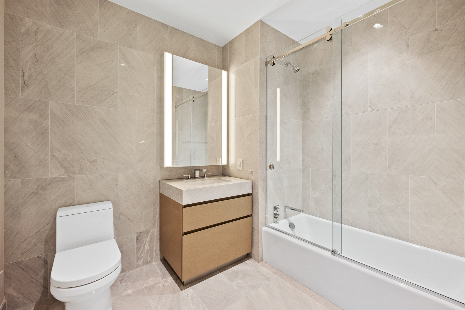 15 Hudson Yards, Unit 77B Manhattan, NY 10001 - Photo 8 of 24 a bathroom with a granite countertop sink a toilet and shower