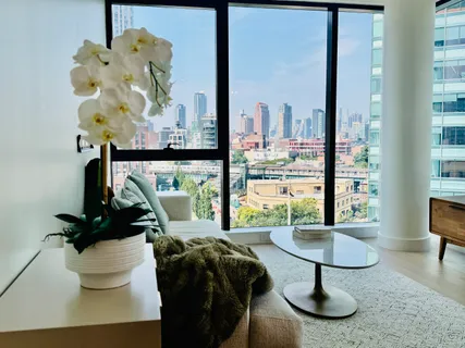 a living room with furniture and a floor to ceiling window