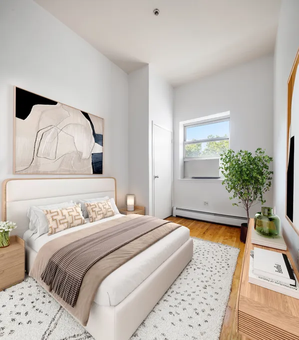 a bedroom with a bed and a potted plant