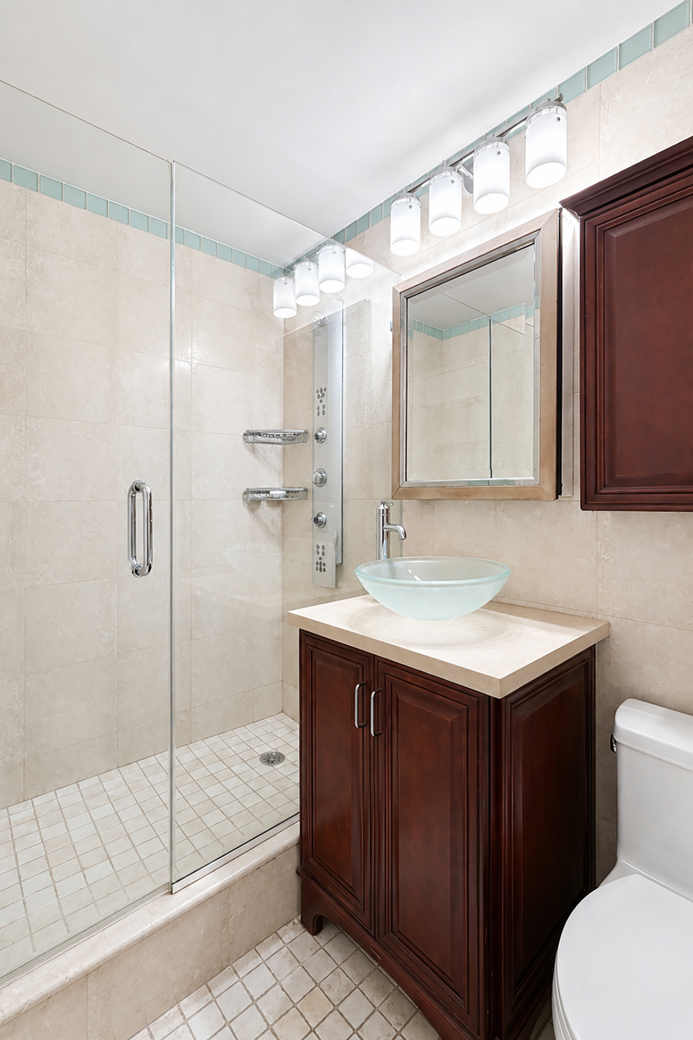 112-01 Queens Boulevard, Unit 21B Queens, NY 11375 - Photo 7 of 25 a bathroom with a shower sink and mirror