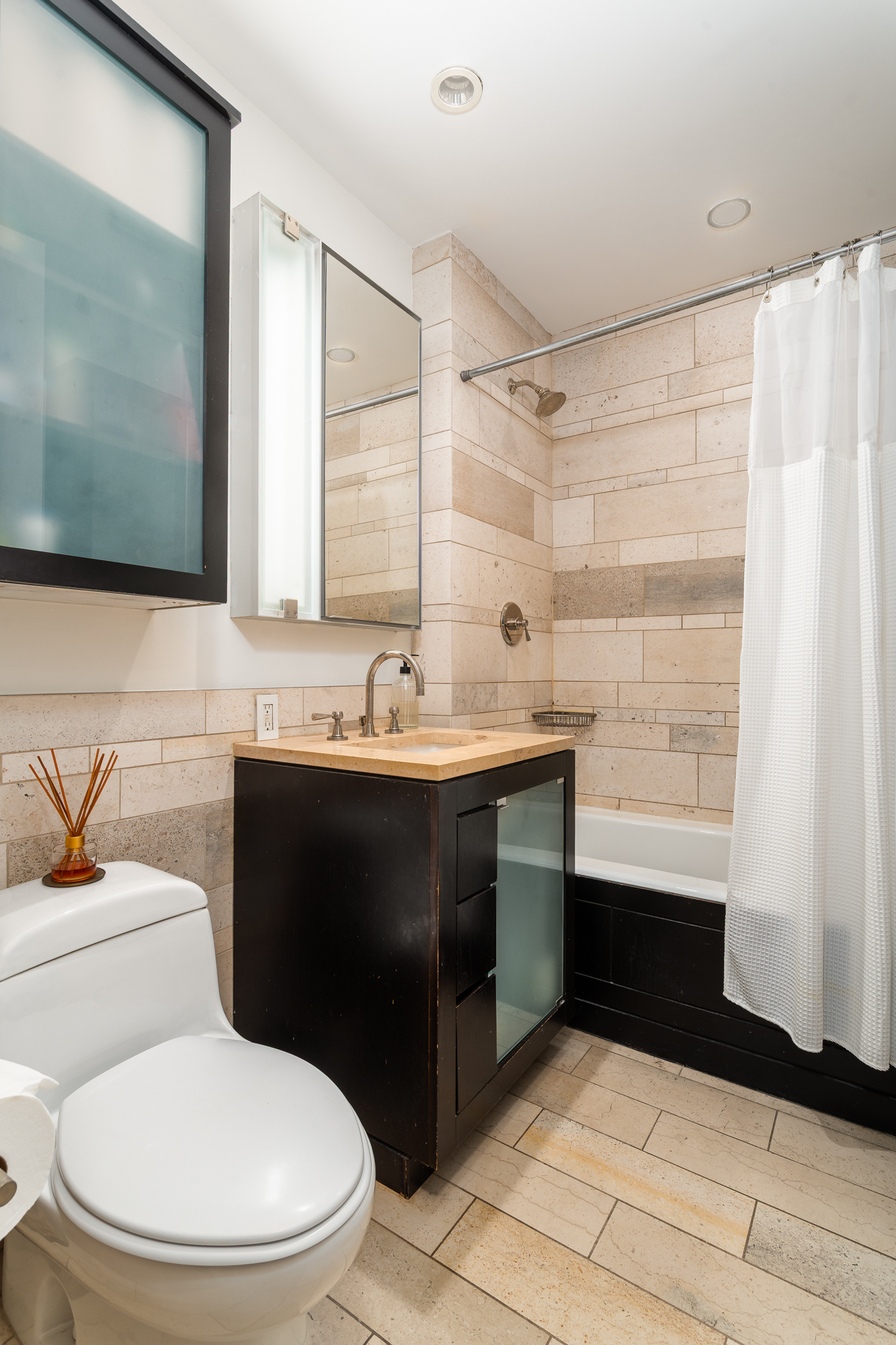 450 East 83rd Street, Unit 5K Manhattan, NY 10028 - Photo 10 of 16 a bathroom with a sink toilet and shower