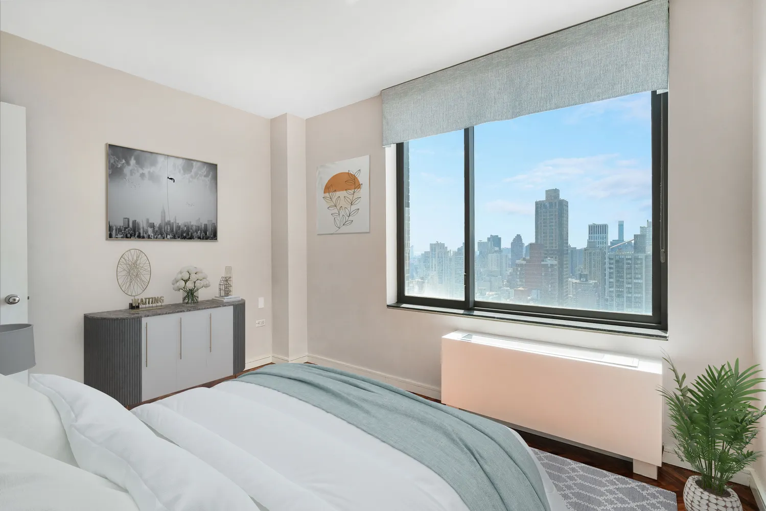 a bedroom with a bed and a painting on the wall